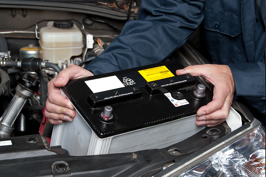 Auto Mechanic replacing battery